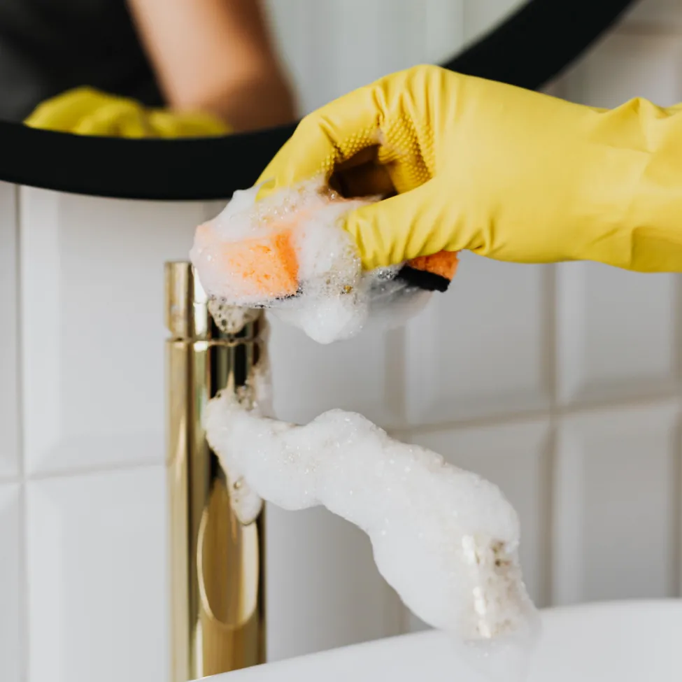 Cristaluxe cleaning technician sanitizing a surface, part of our St. George, UT cleaning services